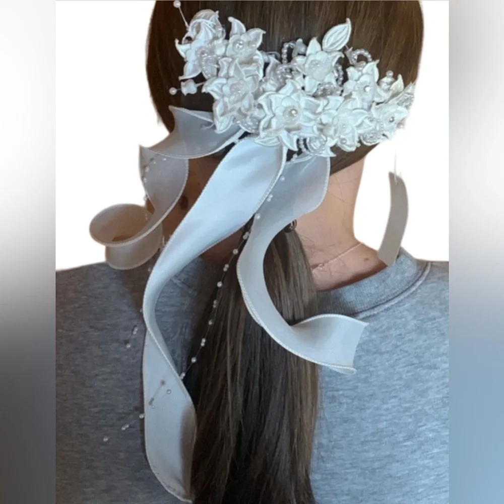 White floral and satin ribbon hairpiece with pearl and rhinestone detail